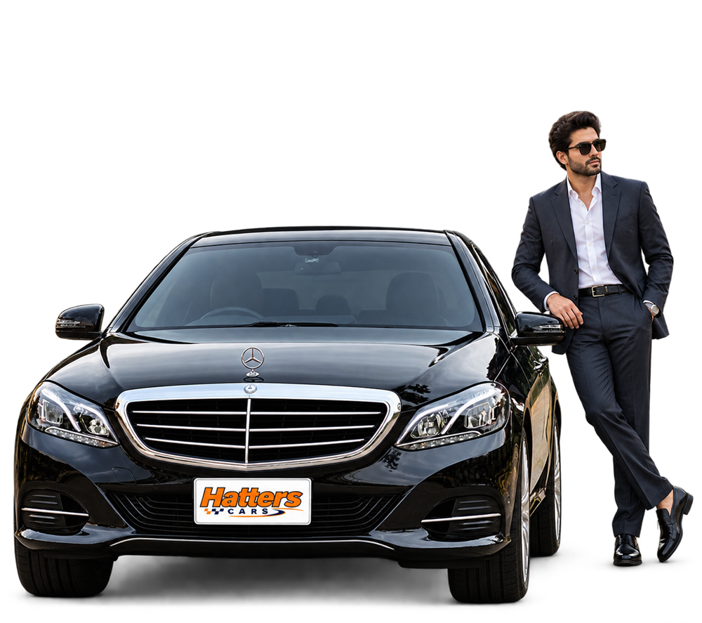 Hatters Cars chauffeur beside a black Mercedes with Hatters plates